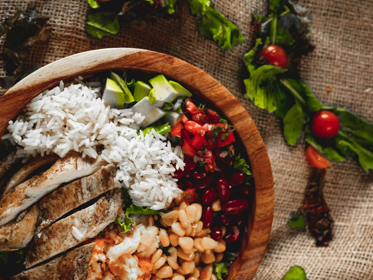 Colorful chicken and rice meal with vegetables.